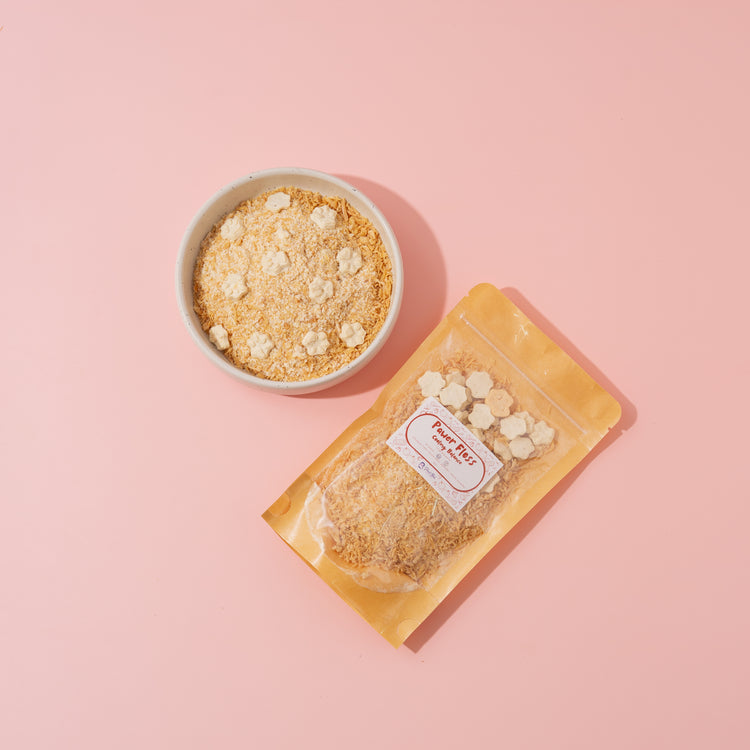 Packaged food item with a bowl of granola on a pink background