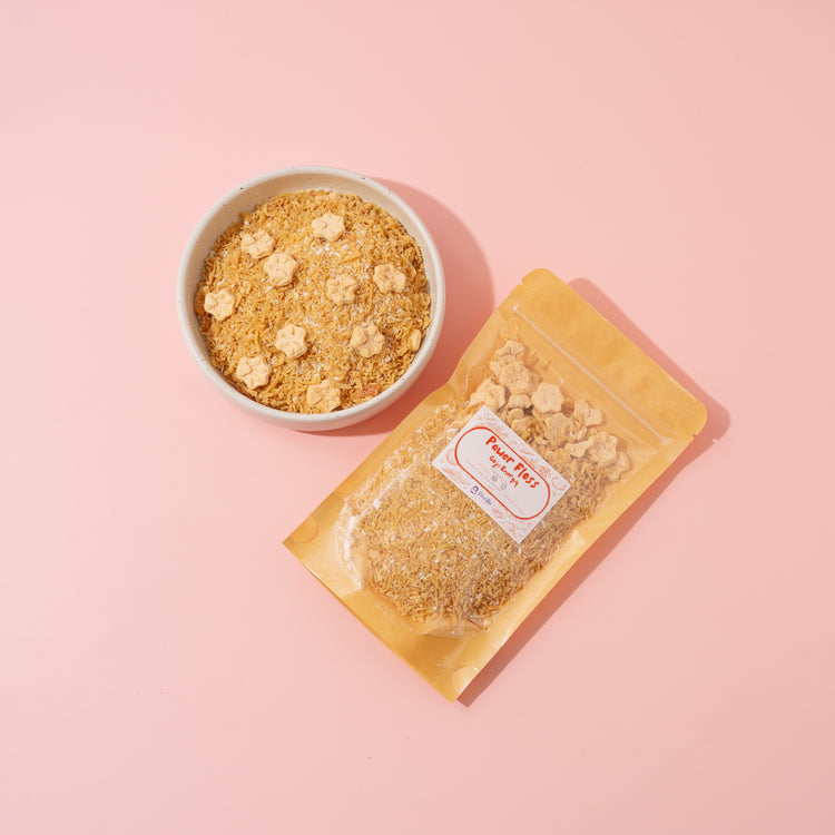 Bowl of granola and packaging on a pink background